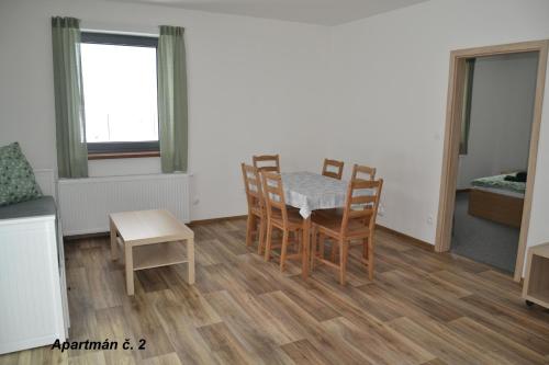 a kitchen and dining room with a table and chairs at Apartmány Benátky in Suchdol nad Lužnicí