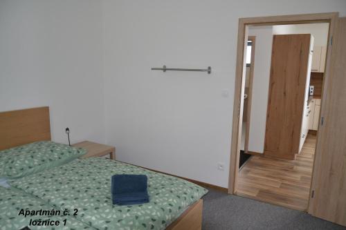 a bedroom with two beds and a door to a room at Apartmány Benátky in Suchdol nad Lužnicí