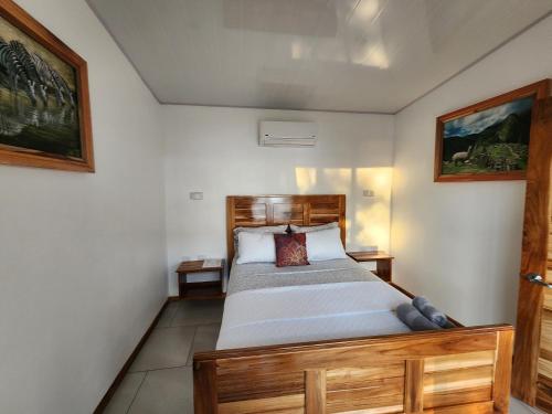 a bedroom with a wooden bed in a room at Canavida Villas & Resort in Uvita