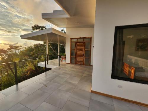a balcony of a house with a painting on the wall at Canavida Villas & Resort in Uvita