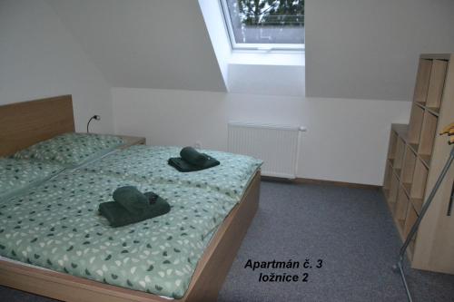 a bedroom with two beds with hats on them at Apartmány Benátky in Suchdol nad Lužnicí