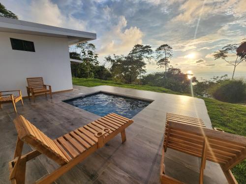 a patio with a bench and a swimming pool at Canavida Villas & Resort in Uvita