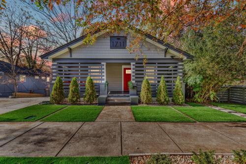 a house with a red door and a yard at Luxury 3BR House in Charlotte in Charlotte