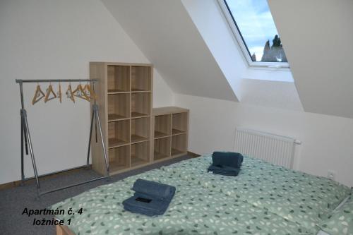 a bedroom with a bed with two blue towels on it at Apartmány Benátky in Suchdol nad Lužnicí