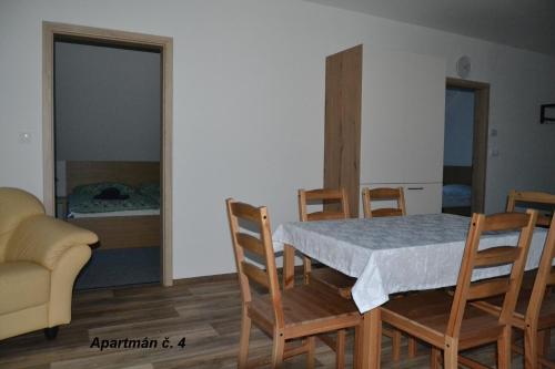 a dining room with a table and chairs and a bedroom at Apartmány Benátky in Suchdol nad Lužnicí