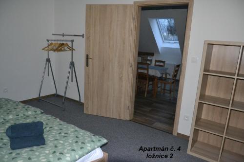 a bedroom with a door leading to a dining room at Apartmány Benátky in Suchdol nad Lužnicí