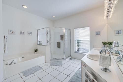 a bathroom with a tub and a shower and a sink at Naples Vacation Rental Home with Heated Private Pool in Naples