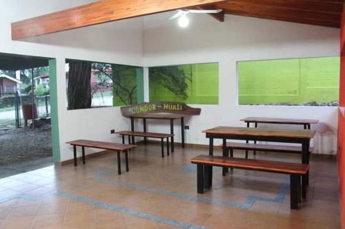 trzy ławki w pokoju ze ścianą z obrazami w obiekcie Cabañas w mieście San Antonio de Arredondo
