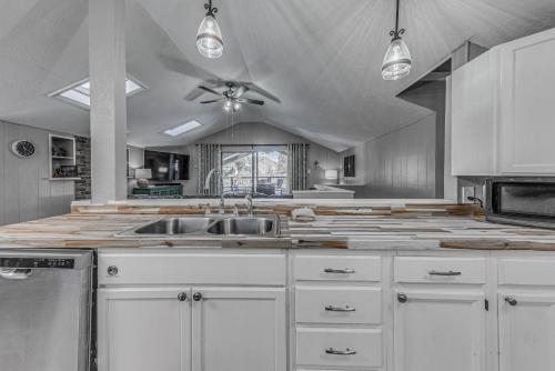 a kitchen with a sink and a ceiling fan at Ruidoso Retreat with Mtn Views about 20 Mi to Ski Apache in Ruidoso