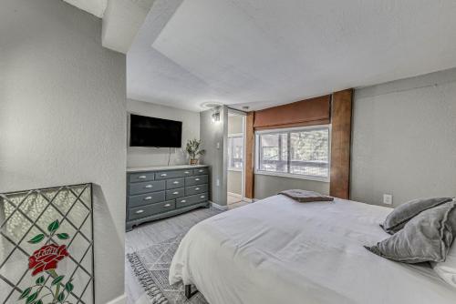 a bedroom with a large bed and a television at Ruidoso Retreat with Mtn Views about 20 Mi to Ski Apache in Ruidoso