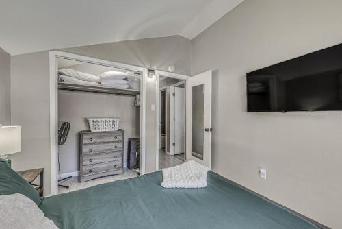 a bedroom with a bed and a flat screen tv at Ruidoso Retreat with Mtn Views about 20 Mi to Ski Apache in Ruidoso