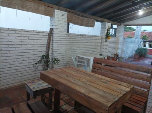 a patio with a wooden bench and a table at Villa Morra House in Asuncion