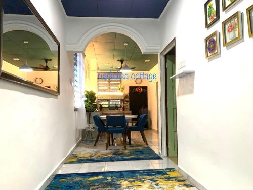 a hallway with a table and chairs in a store at Nadialisa cottage homestay For Islamic only in Sungai Petani
