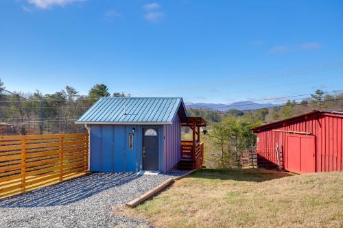 a house with a colorful shed and a fence at Studio with Loft, Hot Tub and Views in Marshall! in Marshall