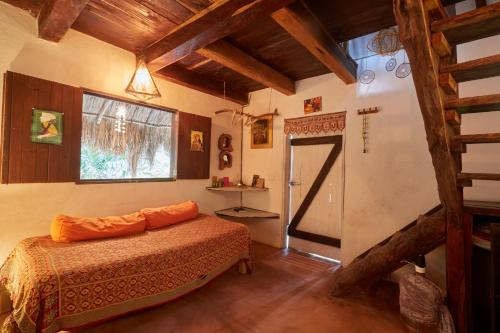 a bedroom with a bed and a window at Corazón de Selva in Macario Gomez