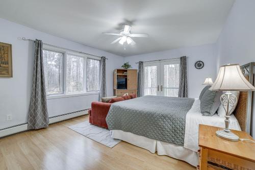 a bedroom with a bed and a ceiling fan at Peaceful Cavendish Retreat with Hot Tub and Fireplace! in Proctorsville