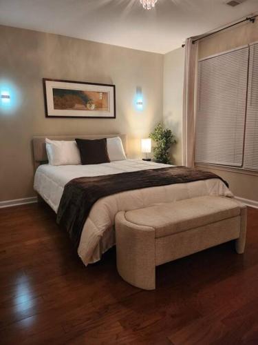 a bedroom with a large bed and a chair at 2,298Sqft-King Bed-BBQ-Gbps-W/D in Snellville