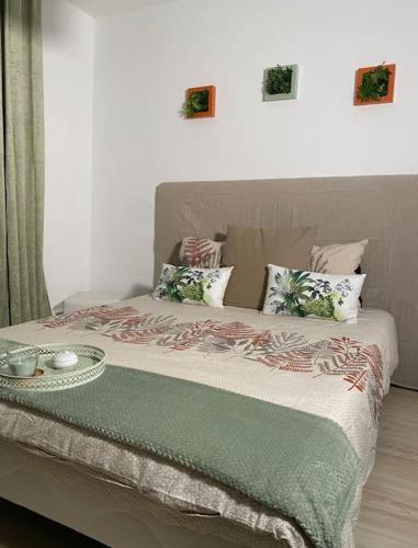 a bedroom with a bed with a tray on it at The place to B&B - vue lac, 3 chambres et parking privé in Évian-les-Bains
