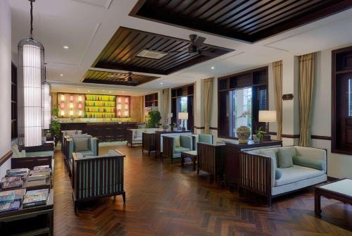 a lobby with couches and chairs and a bar at Wyndham Garden Hoi An Cua Dai Beach in Hoi An