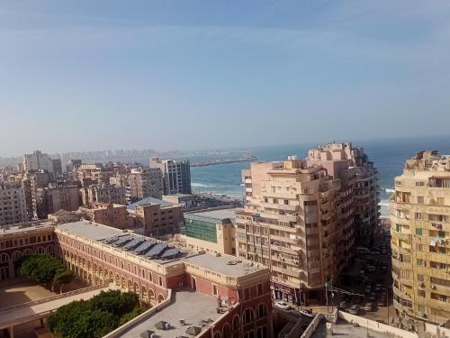 an aerial view of a city with buildings and the ocean at شقة فندقية بالإسكندرية بڤيو لا مثيل له in Alexandria