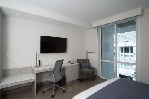 a bedroom with a desk with a computer and a chair at Innovation Hotel in Naples