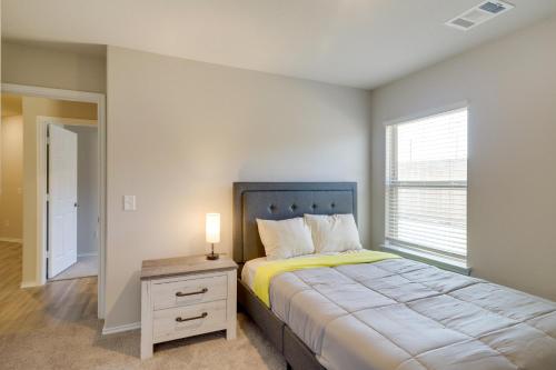 a bedroom with a bed and a lamp on a night stand at Brand New Spring Home Less Than 1 Mi to Old Town! in Spring