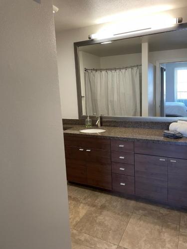 a bathroom with a sink and a large mirror at Casa Marina - Modern, Stylish, Secure & Spacious Condo with 2 Master Suites in MDR & Close to Venice Beach in Los Angeles