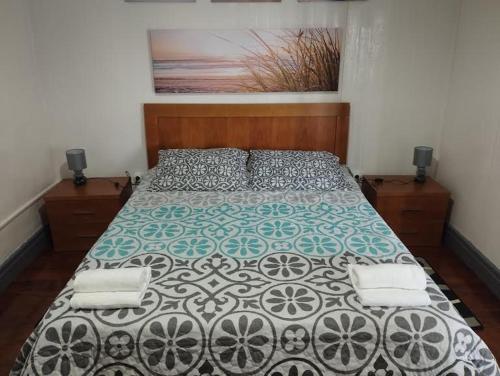 1 dormitorio con cama con edredón en Casa das Palmeiras, en Lajes das Flores