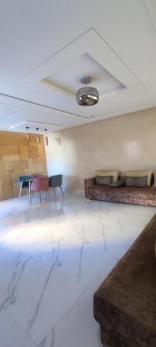 a living room with a couch and a table at surf house Agadir in Tama ou Ennza