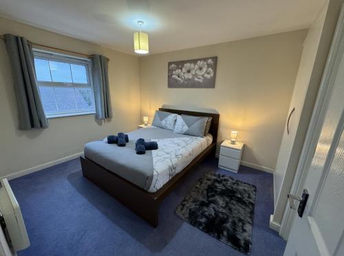 a bedroom with a bed and a window at Modern Penthouse in Wellingborough