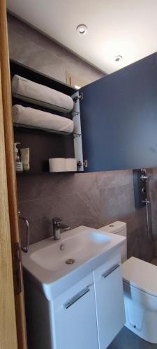 a bathroom with a white sink and a toilet at surf house Agadir in Tama ou Ennza