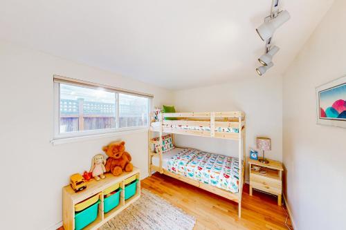 a bedroom with two bunk beds and a window at Schmitz Park Corner in Seattle