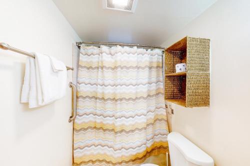 a bathroom with a shower curtain and a toilet at Schmitz Park Corner in Seattle