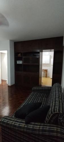 1 dormitorio con 1 cama con cabecero de madera grande en Apartamento Guarapari, en Guarapari