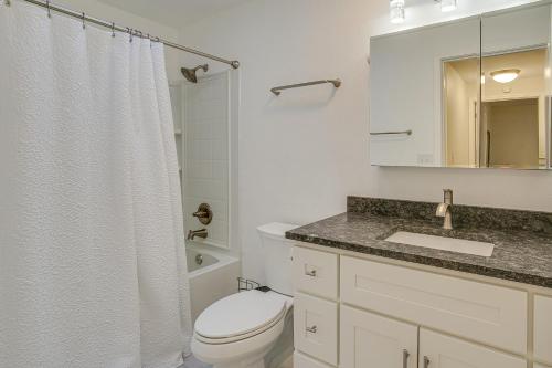 a white bathroom with a toilet and a sink at Modern Puyallup Townhome with Backyard and Fireplace in Puyallup