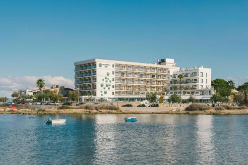 a large building with boats in a body of water at AluaSoul Palma Hotel Adults Only in Can Pastilla