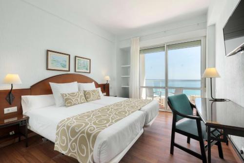 a bedroom with a large bed and a balcony at AluaSun Doblemar in La Manga del Mar Menor
