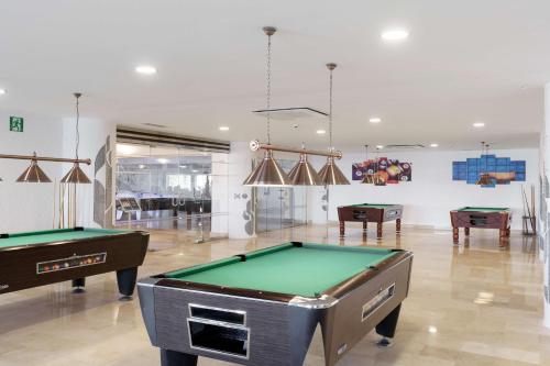 a billiard room with two pool tables in it at AluaSun Doblemar in La Manga del Mar Menor