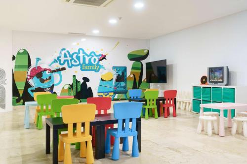 a room with colorful chairs and a painting on the wall at AluaSun Doblemar in La Manga del Mar Menor