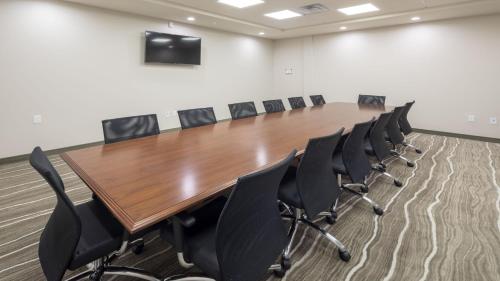 a conference room with a long wooden table and chairs at Staybridge Suites Columbia - Baltimore by IHG in Columbia