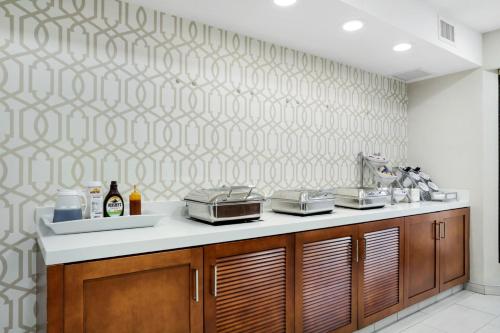 a kitchen with a counter with pots and pans at Staybridge Suites Columbia - Baltimore by IHG in Columbia