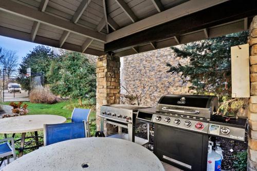 an outdoor kitchen with a grill and a table at Staybridge Suites Columbia - Baltimore by IHG in Columbia