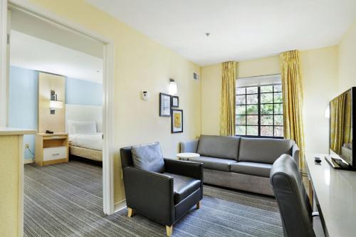 a living room with a couch and a bedroom at Staybridge Suites Columbia - Baltimore by IHG in Columbia