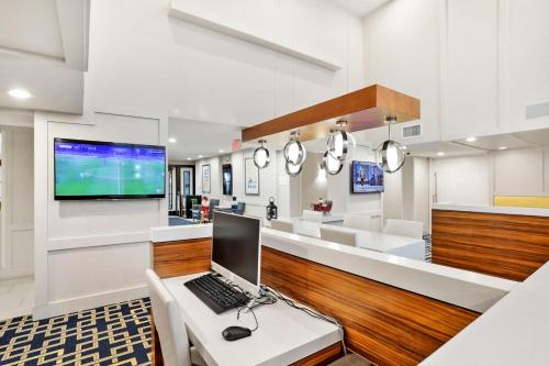 a kitchen with a laptop on a white table at Staybridge Suites Columbia - Baltimore by IHG in Columbia