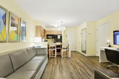 a living room with a couch and a kitchen at Staybridge Suites Columbia - Baltimore by IHG in Columbia