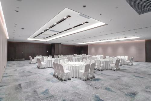 a banquet hall with white tables and chairs and a large room at Holiday Inn Taiyuan Sunshine by IHG in Taiyuan