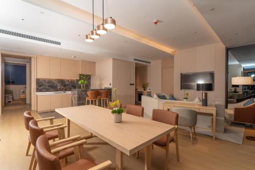 a dining room and kitchen with a table and chairs at Holiday Inn Taiyuan Sunshine by IHG in Taiyuan