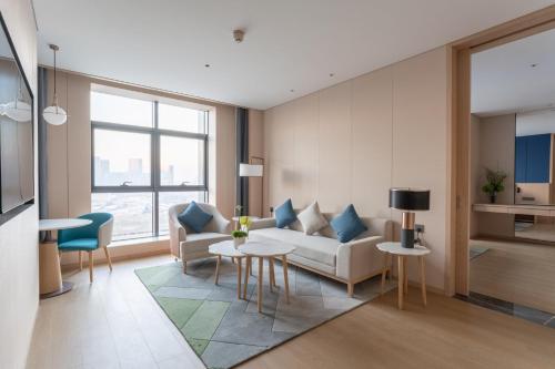a living room with a couch and a table at Holiday Inn Taiyuan Sunshine by IHG in Taiyuan