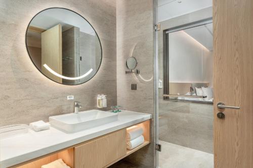 a bathroom with a sink and a mirror at Holiday Inn Taiyuan Sunshine by IHG in Taiyuan