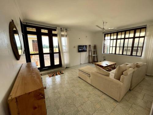 a living room with a couch and a table at Mintari Penthouse, Nyali. in Mombasa
